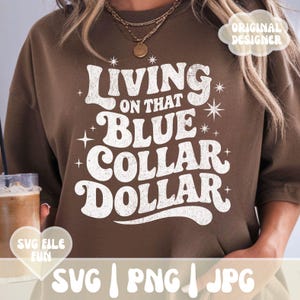 May include: Brown sweatshirt with the text "Living on that Blue Collar Dollar" in a retro font. The design includes starburst and cross accents. The words "SVG File Fun" and "Original Designer" are also visible.
