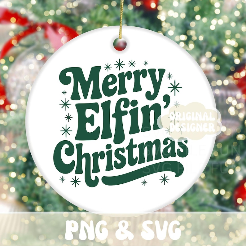 May include: White ceramic Christmas ornament with the text "Merry Elfin' Christmas" in dark green. The ornament has a gold string for hanging and is decorated with snowflakes. The background is a blurred image of a Christmas tree.