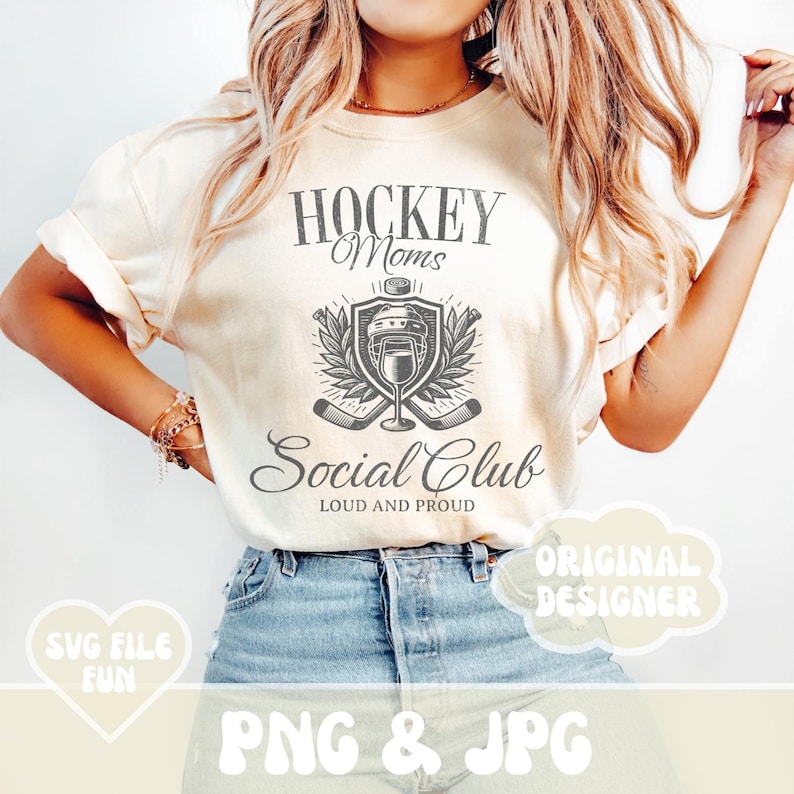May include: A white t-shirt with a graphic design that says "Hockey Moms Social Club Loud and Proud". The graphic features a hockey helmet, hockey sticks, and a glass of wine.