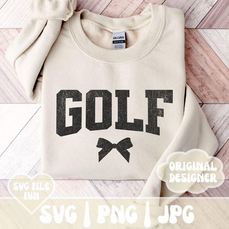 May include: A beige sweatshirt with the word "GOLF" in black distressed lettering and a black bow underneath. The text "ORIGINAL DESIGNER" is in a white cloud shape on the bottom right corner of the sweatshirt.