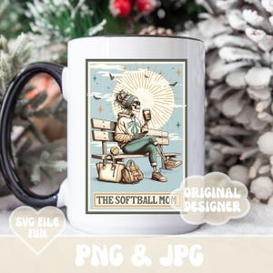 May include: White ceramic mug with a black handle and a black rim. The mug features a colorful illustration of a skeleton sitting on a bench with a coffee cup and a baseball. The text "The Softball Mom" is printed on the mug.