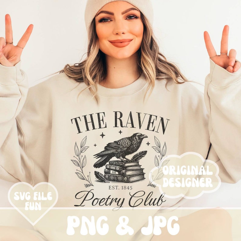 May include: A beige sweatshirt with a black and white graphic design featuring a raven perched on a stack of books. The graphic also includes the text "The Raven Poetry Club Est. 1845". The sweatshirt is being modeled by a person with long blonde hair and a white beanie.