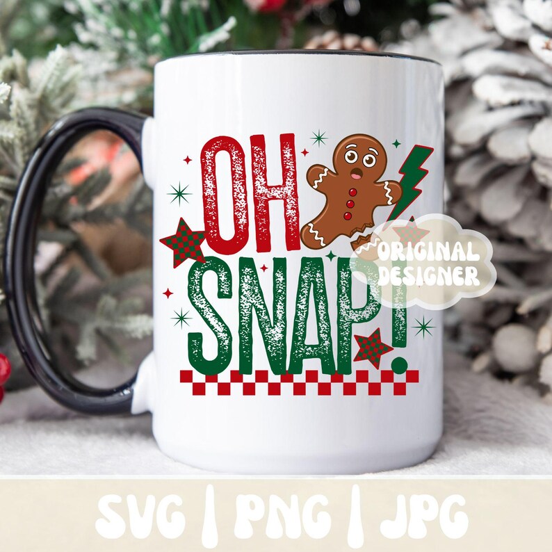 May include: White ceramic mug with a black handle and rim, featuring the text "OH SNAP!" in red and green, along with a gingerbread man and lightning bolt graphic. The mug has a festive, holiday theme.