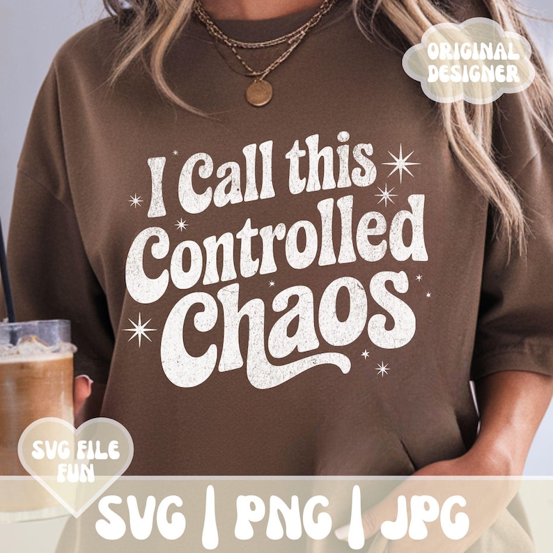 May include: A brown sweatshirt with the text "I Call this Controlled Chaos" in white, stylized font. The design includes starburst accents. The image also includes the text "SVG | PNG | JPG" and the words "SVG FILE FUN".