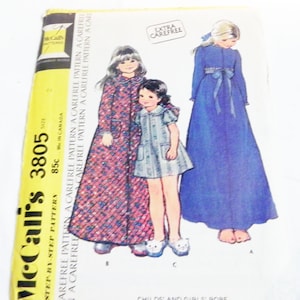 May include: Vintage McCall's 3805 sewing pattern for Childs' and Girls' robes. The pattern cover features illustrations of three different robe designs. The pattern includes the text "EXTRA CAREFREE" and "STEP-BY-STEP PATTERN".