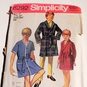 May include: Vintage Simplicity pattern 8292 for boys' robes and dressing gowns. The pattern includes sizes for a 30-inch chest and a 25.5-inch waist. The image shows illustrations of the finished garments in blue, plaid, and red.
