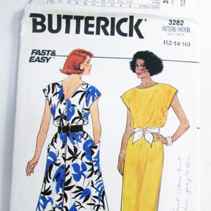May include: A vintage Butterick sewing pattern featuring illustrations of two dresses. One dress is white with blue floral print, the other is yellow. The pattern number is 3282, and the size range is 12-14-16.