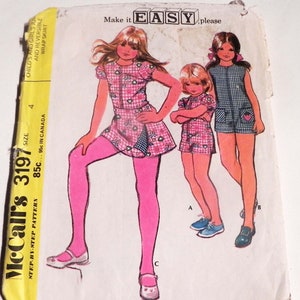May include: A vintage McCall's 3197 sewing pattern envelope featuring illustrations of children wearing a reversible wrap skirt and jumper. The text reads Make it EASY, please, Child's and Girl's Jumper and Reversible Wrap Skirt, and size 4.