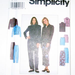 May include: A Simplicity sewing pattern packet featuring a woman's suit design. The packet includes images of the finished garments, including a jacket, pants, and skirt. The pattern number is 8398, with size Z, and the Simplicity logo is visible.