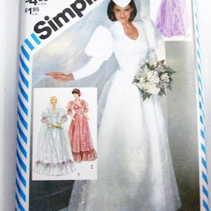 May include: Simplicity sewing pattern for a wedding dress. The pattern features a bride in a white gown with a bouquet, and illustrations of other dress styles. The package has a blue and white striped border.