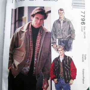 May include: McCall's sewing pattern 7796 for a jacket in size Large (42, 44). The envelope features illustrations of two jacket styles: a solid tan bomber jacket and a plaid jacket with red sleeves, along with a photograph of a tan jacket.