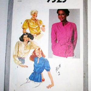 May include: Vintage Simplicity sewing pattern 9323, size 10 Miss. The pattern features illustrations of blouses in yellow, white, blue, and pink. The pattern includes a pink blouse with a tie belt and a blue blouse with short sleeves.