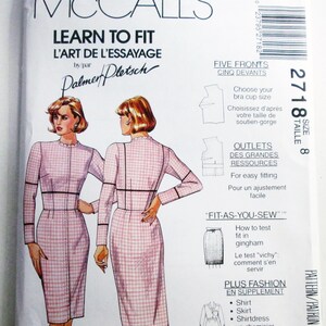 May include: A McCall's Learn to Fit sewing pattern envelope, size 8, featuring illustrations of a pink and white gingham dress. The text includes 'L'Art de l'Essayage', 'Palmer/Pletsch', 'Five Fronts', 'Outlets', 'Fit-As-You-Sew', and 'Plus Fashion'.