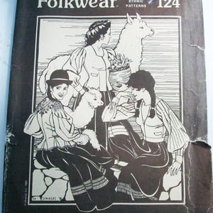 May include: A brown paper sewing pattern envelope titled Folkwear 124 Bolivian Milkmaid's Jacket. The cover features a black and white illustration of three individuals in long-sleeved jackets and skirts, with two llamas and text detailing patterns for three versions.