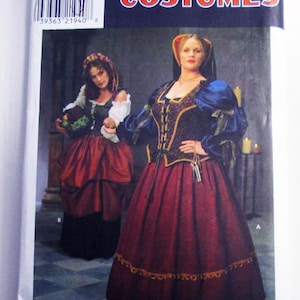 May include: A Simplicity Costumes sewing pattern envelope, number 8249, featuring illustrations of two historical-style outfits. One outfit includes a dark red skirt and a dark bodice with blue sleeves. The other features a red skirt and a dark vest.