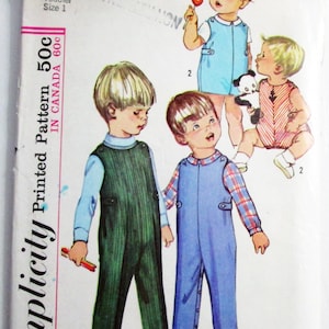 May include: A Simplicity sewing pattern envelope labeled 6157 for toddler size 1. The front features illustrations of children wearing overalls and rompers in green, blue, and red striped patterns, with text including Printed Pattern 50c.