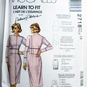 May include: McCall's Learn to Fit sewing pattern 2718, size 18. The envelope features illustrations of a long-sleeved, pink and white gingham dress with a high neckline and dark trim. Text includes instructions for bra cup sizing and fit testing.