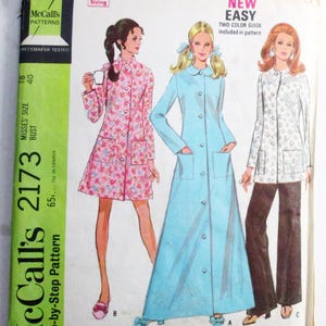 May include: A vintage McCall's 2173 sewing pattern envelope for a robe in three lengths and pants. The cover features illustrations of three outfits: a short pink floral robe, a long light blue robe, and a white patterned jacket with dark pants.