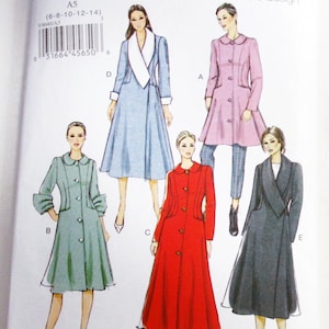 May include: Vogue Basic Design V9040 sewing pattern envelope featuring illustrations of five coat variations labeled A through E. The designs include various collar styles, button closures, and lengths in colors including light blue, pink, green, red, and dark gray.