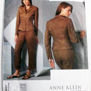 May include: A brown suit pattern by Anne Klein, featuring a blazer and pants. The pattern includes sizes 8-12. The Vogue American Designer pattern is displayed on a white background.