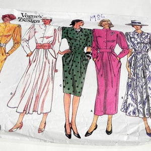 May include: Vogue's Basic Design sewing pattern featuring five dress designs. The dresses are in various colors and patterns, including yellow, white, green with black polka dots, pink, and white with blue floral print. The pattern is from 1986.