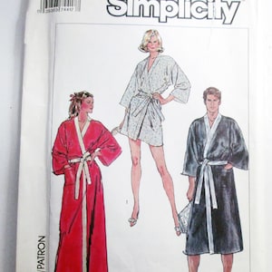May include: A Simplicity sewing pattern envelope, number 7441, size LG. The front features illustrations of three robe styles: a long red robe, a short light-colored floral robe, and a long dark robe, all with white trim and waist ties.