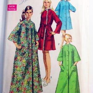 May include: Vintage Simplicity sewing pattern featuring illustrations of women's robes in various colors and patterns. The pattern includes sizes 8-10 for Misses. The cover has the text "Simplicity" and "New Sizing".