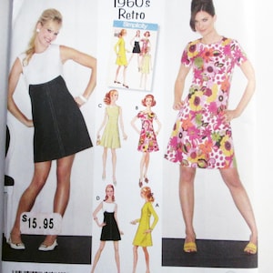 May include: Simplicity sewing pattern featuring 1960s retro dresses. The pattern includes various dress styles, with illustrations of the finished garments. The pattern's size range is R5, 14, 16, 18, 20, and 22. The price tag shows $15.95.