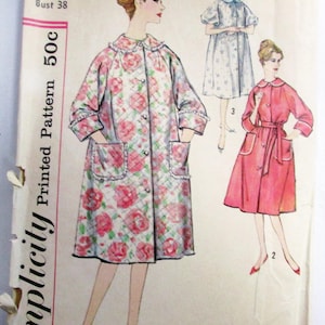 May include: Simplicity sewing pattern 3216 for a quilted robe or coat with a floral print, featuring a Peter Pan collar, three-quarter sleeves, and patch pockets. The envelope displays three variations of the garment, including a solid pink version.