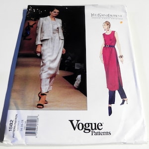 May include: A Vogue Patterns sewing pattern featuring a YVES SAINT LAURENT design. The pattern includes a model wearing a light-colored suit with a jacket, dress, and pants. The pattern number is 1582.