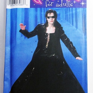May include: Simplicity costume pattern for adults. The pattern features a long black coat with a lace-up front, worn by a person wearing sunglasses. The text "Costumes for adults" is visible on the pattern.