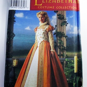 May include: Simplicity Elizabeth Costume Collection sewing pattern. The pattern features a woman in an orange, white, and gold gown. The bodice has a floral design. The pattern includes sizes 14, 16, 18, and 20.