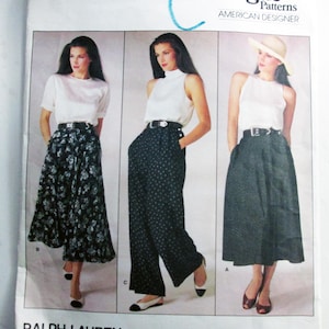May include: A Vogue Patterns American Designer sewing pattern envelope by Ralph Lauren, number 1723. The cover features three illustrations of outfits including a floral skirt, wide-leg polka dot trousers, and a dark skirt, all paired with white tops.