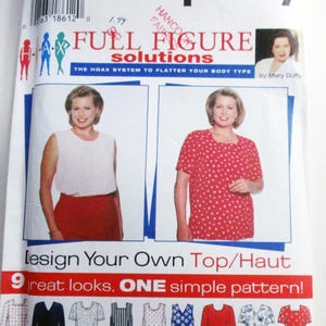May include: A Simplicity sewing pattern envelope titled Full Figure Solutions by Mary Duffy, featuring illustrations of two tops with polka dot patterns, one sleeveless and one short-sleeved, along with nine variations of top designs printed at the bottom.