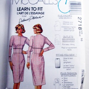 May include: A McCall's Learn to Fit sewing pattern envelope, size 16, featuring illustrations of a long-sleeved dress with a pink and white checkered pattern. The white paper packaging includes text in English and French, diagrams for fitting, and a barcode.