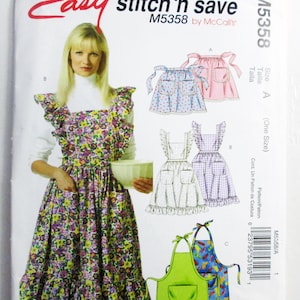 May include: A sewing pattern envelope for Easy stitch 'n save M5358 by McCall's. The front shows a person wearing a floral print apron with ruffles and pockets, alongside illustrations of three different apron styles labeled A, B, and C.