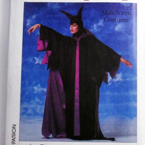 May include: A Simplicity sewing pattern envelope for a Maleficent costume in sizes 6 and 8. The cover features a person wearing a long black robe with purple accents and a horned headpiece against a blue sky background with the Walt Disney logo.