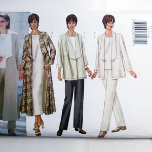 May include: Butterick sewing pattern featuring three women's outfits: a long beige coat with matching pants, a patterned long coat over a dress, and a white suit. The pattern number is 6473.