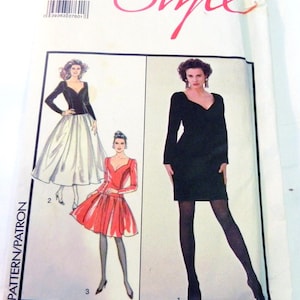 May include: A vintage sewing pattern titled "Style" featuring illustrations of three different dress designs. The pattern packet is white with pink text and includes sizing information. The dresses include a black dress, a red dress, and a black and white dress.