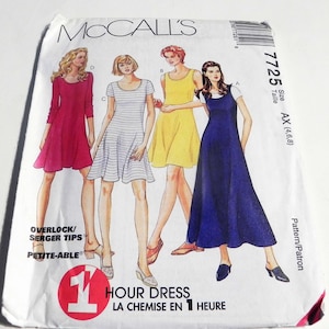 May include: A McCall's sewing pattern envelope featuring illustrations of four different dresses. The dresses are in various colors, including pink, yellow, and blue. The envelope includes text that reads "1 Hour Dress" and "Petite-Able". The pattern size is AX (4,6,8).