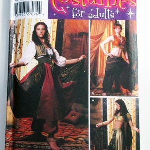 May include: Simplicity costume pattern for adults. The package features three images of women wearing different costume designs. The costumes include a long skirt, harem pants, and a crop top. The package has the text "Costumes for adults" and the pattern number 5359.