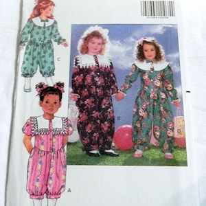 May include: A vintage Butterick sewing pattern featuring illustrations of children's clothing. The pattern includes designs for dresses and rompers with floral prints and white collars. The pattern number is 5584.