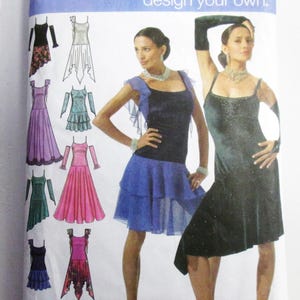 May include: Simplicity sewing pattern featuring designs for dresses. The pattern includes illustrations of various dress styles in colors like black, blue, pink, and green. The models are wearing the dresses. The pattern size is P5, with measurements in inches.