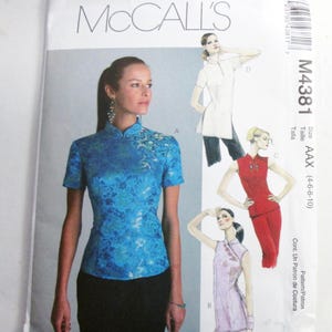 May include: A McCall's M4381 sewing pattern envelope featuring illustrations of four variations of a mandarin collar top. The main image shows a bright blue floral brocade top with short sleeves and a high collar, paired with a black skirt.