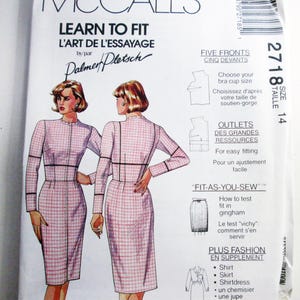 May include: A McCalls Learn to Fit sewing pattern envelope, number 2718, size 14. The front features illustrations of a long-sleeved, pink and white gingham dress with black trim, alongside text detailing fitting techniques and additional garment options.