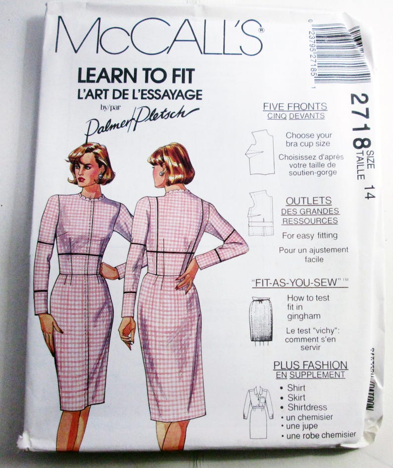 May include: A McCalls Learn to Fit sewing pattern envelope, number 2718, size 14. The front features illustrations of a long-sleeved, pink and white gingham dress with black trim, alongside text detailing fitting techniques and additional garment options.