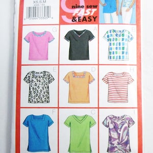May include: A sewing pattern package featuring nine different t-shirt designs. The package includes a variety of styles, including solid colors, patterns, and striped options. The Butterick pattern is labeled "Fast & Easy" and includes sizes XS, S, and M.