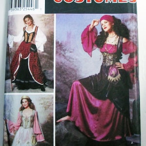 May include: Simplicity Costumes pattern featuring medieval and Renaissance-style dresses. The package includes images of various costume designs, with a focus on long gowns in shades of red, black, and pink. The pattern includes sizes 14, 16, 18, and 20.