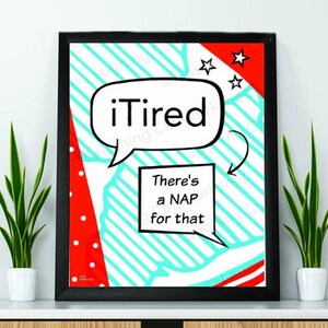May include: A black framed print with a red, white, and blue comic book style design. The print features a speech bubble with the text "iTired" and another speech bubble with the text "There's a NAP for that".