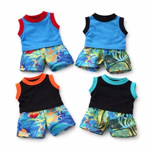May include: Four sets of children's tank tops and shorts. The tank tops are blue, black, and trimmed with red, orange, and turquoise. The shorts have a colorful tropical fish and coral reef pattern.